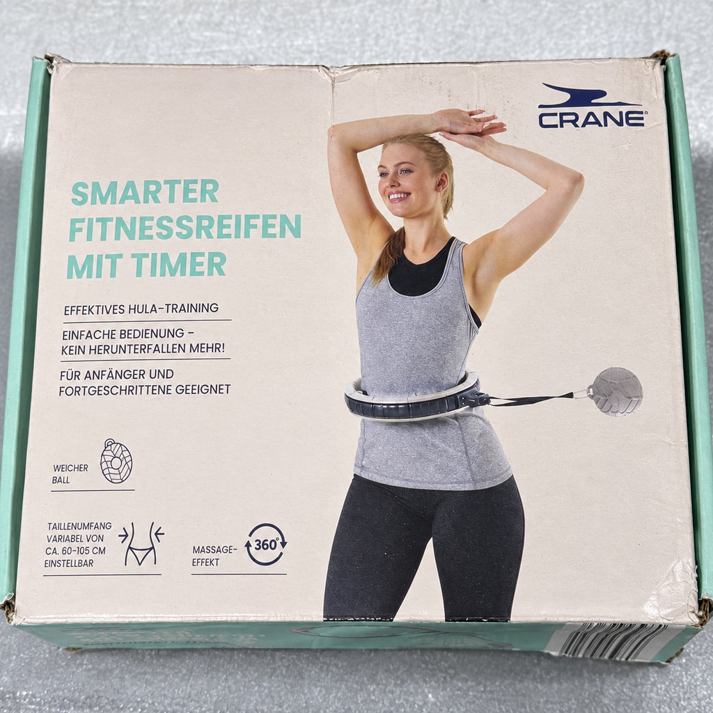 Caja CRANE de aro de fitness gris con temporizador; desgaste visible en el embalaje