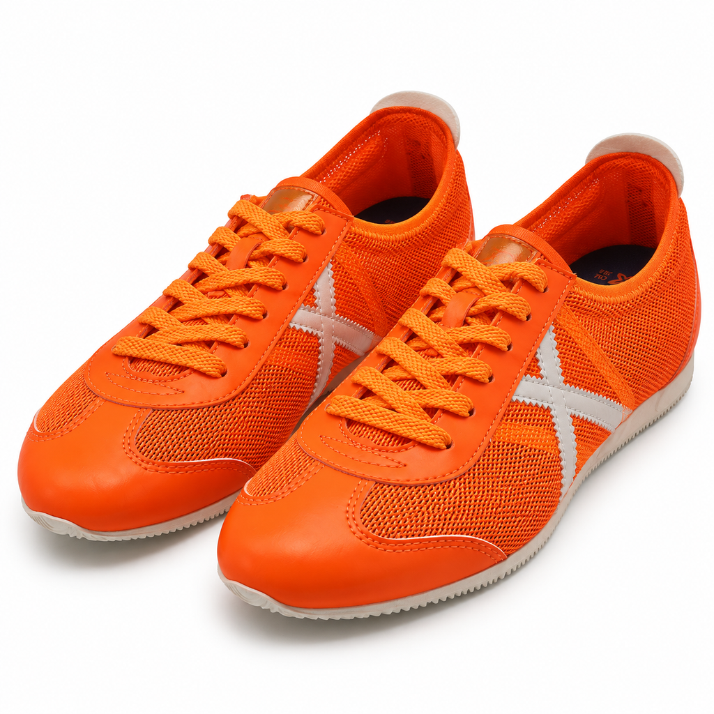 Zapatillas Munich naranjas con detalles plateados sobre fondo blanco