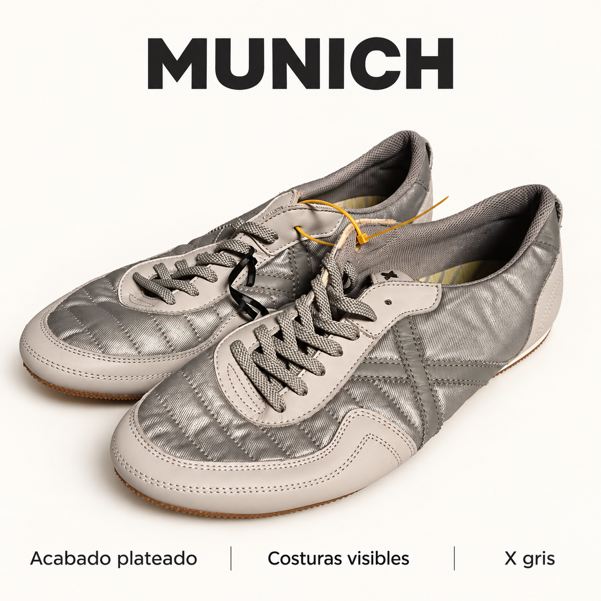 Detalles del acabado plateado, las costuras visibles y la X gris de Munich